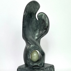 conceptionne-thumbnail Dark green polished stone sculpture with a curved, looping form cradling a pale round stone, on a matching green marble base.
